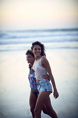Image showing Some beach time is all you need. two young women enjoying themselves at the beach.