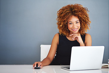 Image showing Technology keeps my business current. Portrait of a young businesswoman working on a laptop at her desk.