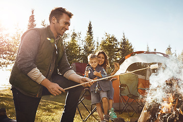 Image showing Lets roast some marshmallows. a young family camping in the forest.