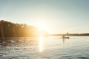Image showing In the middle of nowhere is where you find yourself. a young man kayaking on a lake outdoors.