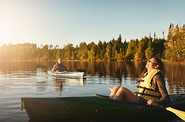 Image showing Kayaking is cheaper than therapy. a young couple kayaking on a lake outdoors.