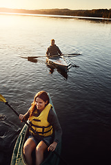 Image showing Who wouldve thought this would be so much fun. High angle shot of a young couple kayaking on a lake outdoors.