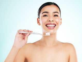 Image showing Brush thoroughly. Studio portrait of an attractive young woman brushing her teeth against a light background.