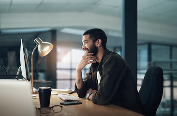 Image showing Beating the deadline before the day is done. a young businessman using a computer during a late night in a modern office.