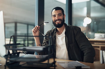 Image showing It doesnt feel late if you love what you do. a young businessman using a computer during a late night in a modern office.