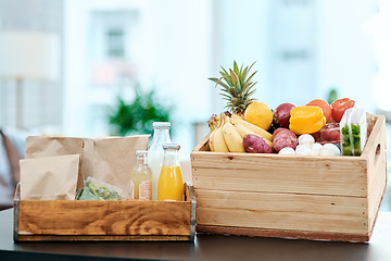Image showing Make your home a hub of health. a box full of fresh produce on a kitchen counter at home.