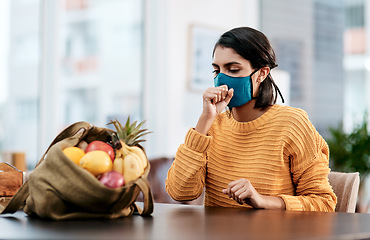 Image showing Not just groceries you could bring back from the store. a masked young woman coughing after returning home from buying groceries.