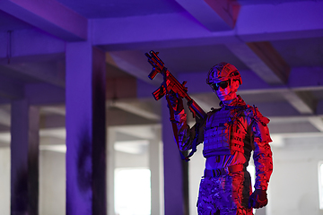 Image showing A professional soldier undertakes a perilous mission in an abandoned building illuminated by neon blue and purple lights