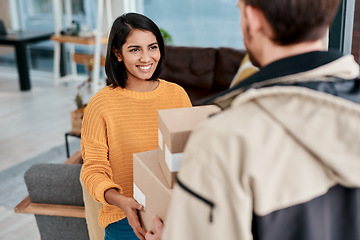 Image showing The best delivery guys are always there for you. a young woman receiving a package from a delivery man at home.