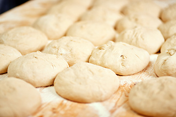 Image showing Ready for the oven. a bunch of rolls on a baking tray ready to be placed into the oven.