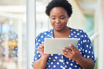 Image showing The do your work anywhere device. a young businesswoman using a digital tablet in a modern office.