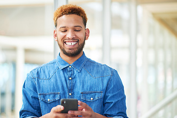 Image showing Gaining more followers with an attention grabbing social media post. a young businessman using a smartphone in a modern office.