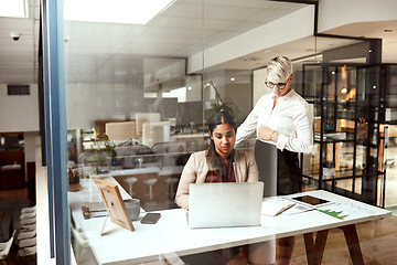 Image showing Making sure everything is done correctly. two businesswomen working together on a laptop in an office.