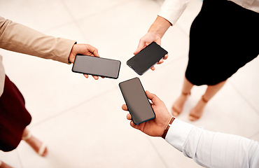 Image showing Closing in on their business connections. Closeup shot of a group of unrecognisable businesspeople holding cellphones.
