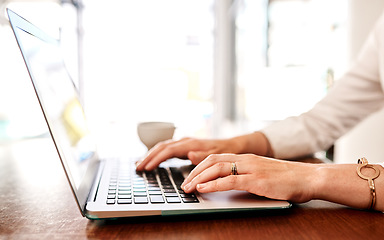 Image showing Shes swift with her replies via email. Closeup shot of an unrecognisable businesswoman using a laptop in an office.