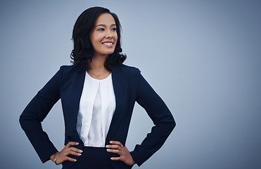 Image showing Go for all your big dreams. Studio shot of a young businesswoman standing with her hands on her hips against a grey background.