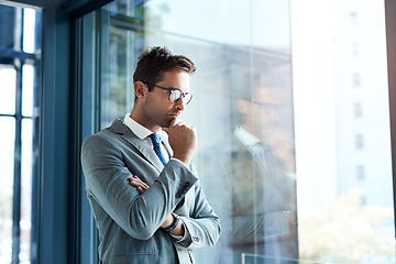 Image showing Hes planning to franchise all over the city. a professional businessman looking thoughtful while standing in his office.