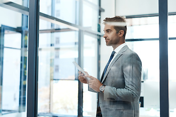 Image showing Technology speeds up the brainstorming process. a professional businessman using a digital tablet in his office.