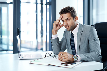 Image showing Planning all the necessary steps to succeed. a businessman looking stressed while sitting at his desk.