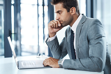 Image showing No one said it would be easy. a professional businessman sitting at his desk.