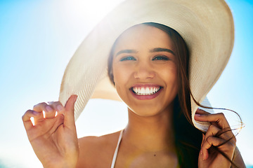 Image showing Living on the sunny side of life. Closeup shot of a beautiful young woman spending some time at the beach.