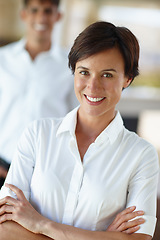 Image showing Nothing worth having comes easy. Portrait of a confident businesswoman with a colleage standing in the background.