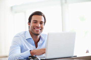 Image showing Theres no substitute for hard work. Portrait of a handsome businessman using his laptop in the office.