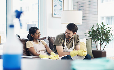 Image showing The daily routine couldn’t dull the shine of their love. a happy young couple taking a break together after cleaning their home.