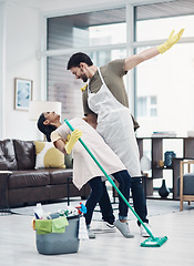 Image showing Nothing inspires productivity like passion. a happy young couple dancing while mopping the floor at home.