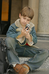 Image showing Schoolboy sitting on steps