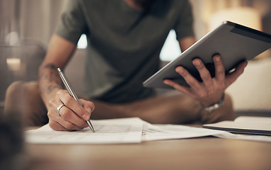 Image showing The handiest budgeting tool there is. a man using a digital tablet while going through paperwork at home.