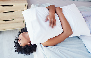 Image showing Im super bored. a woman embracing her pillow while lying on her bed.