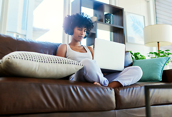 Image showing A blogpost a day keeps the boredom away. a woman using her laptop while sitting on the couch at home.