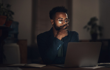 Image showing Dedication beats the deadline every time. a young businessman using a laptop during a late night at work.