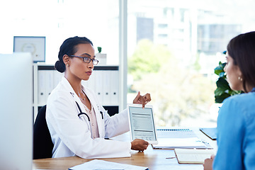 Image showing Incorporating smart tech into her consultations. a young doctor using a digital tablet during a consultation with her patient.