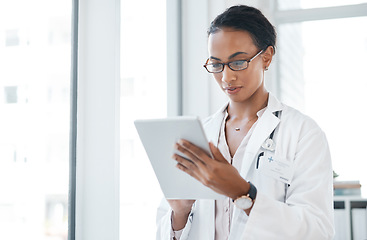 Image showing I have to tell someone about this. a young doctor using her digital tablet at work.