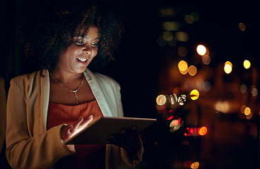 Image showing Everyone else is sleeping but not the dedicated. a businesswoman using a digital tablet in an office at night.