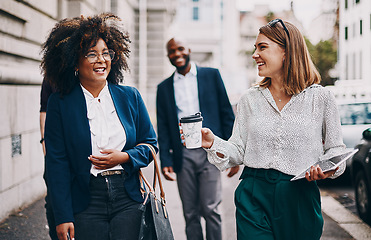 Image showing Business minded people always get along. two businesswomen having a discussion while walking through the city together.