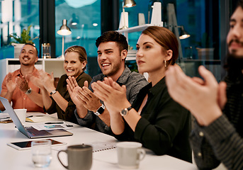 Image showing This presentation was very informative. a group of businesspeople applauding while sitting in the boardroom.