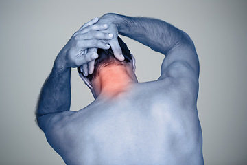 Image showing In so much pain. Rear view shot of a mature man with neck pain thats highlighted in red.