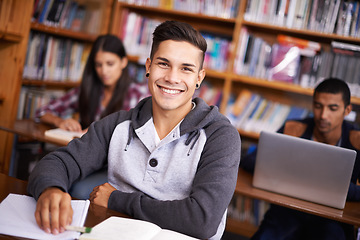 Image showing Hes such a diligent student. Cropped portrait of a handsome young student working diligently in his classroom.