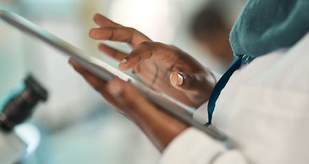 Image showing Bettering her research with the help of smart tech. Closeup shot of an unrecognisable scientist using a digital tablet in a lab.