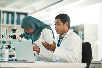 Image showing What just happened. a young scientist looking shocked while working on a laptop alongside a colleague in a lab.