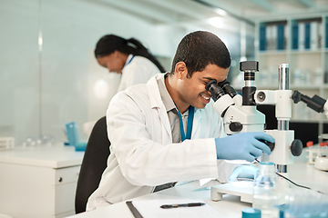 Image showing I can sense a new breakthrough coming along. a young scientist using a microscope in a lab.