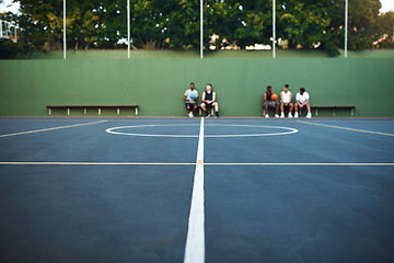 Image showing Play hard or go home. a group of sporty young men sitting on a basketball court.