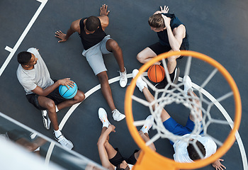 Image showing Sport plays an important role in keeping communities together. High angle shot of a group of sporty young men hanging out on a basketball court.