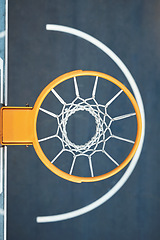 Image showing Quest for the net. Closeup shot of a basketball hoop on a sports court.