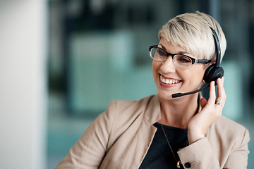 Image showing The outcome of her calls are always successful. a young businesswoman wearing a headset while working in an office.