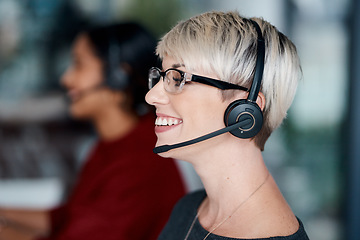 Image showing We have all the expert advice you need. a young businesswoman wearing a headset while working in an office.