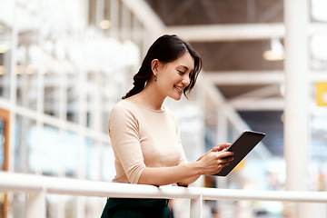 Image showing Its so easy to make success mine. a young businesswoman using a digital tablet in an office.